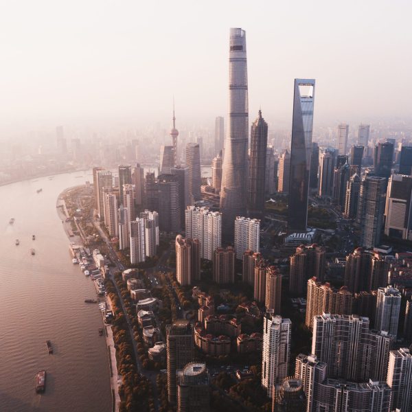 A beautiful overhead shot of Shanghai city skyline with tall skyscrapers and a river on the side